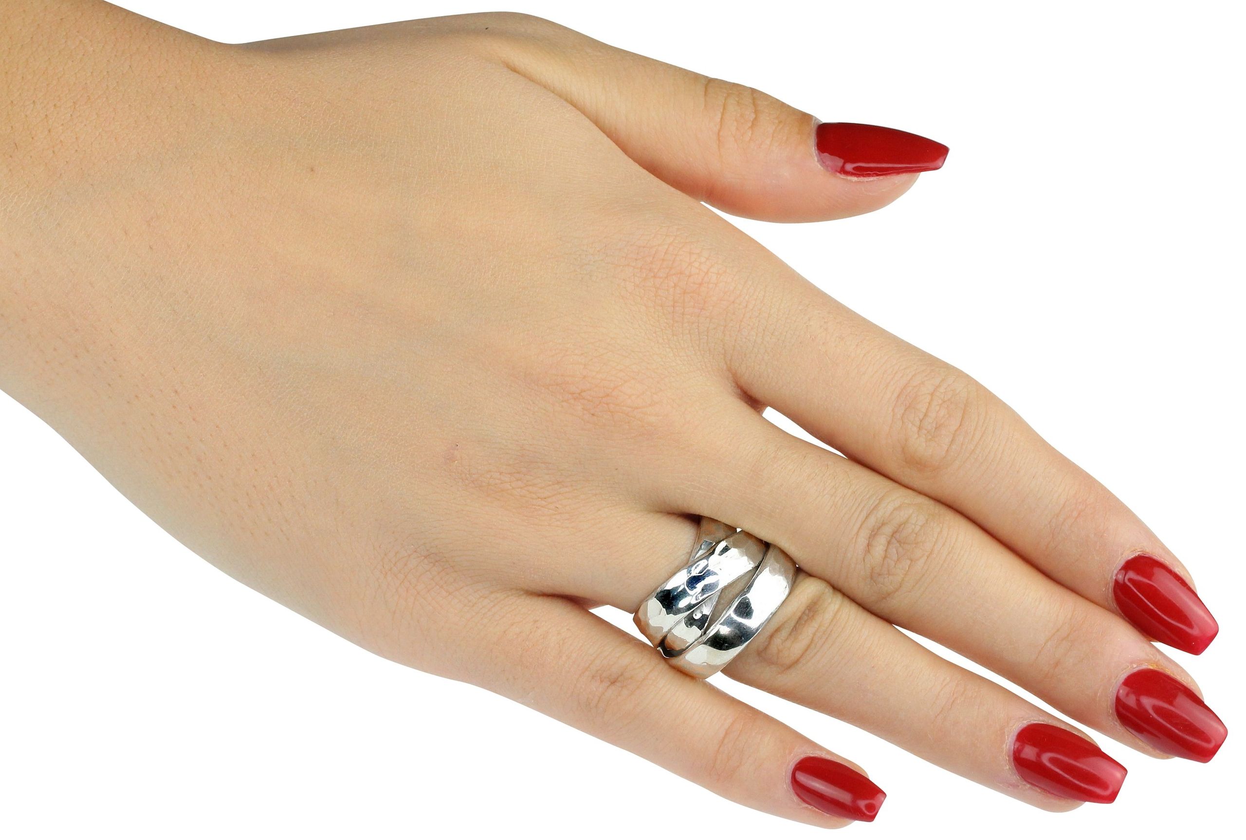 Eleganter Damenring aus Silber mit drei fest verbundenen Ringschienen, getragen an einer Damenhand. Der Ring ist geschmiedet und hat eine leicht gehämmerte Oberfläche.
