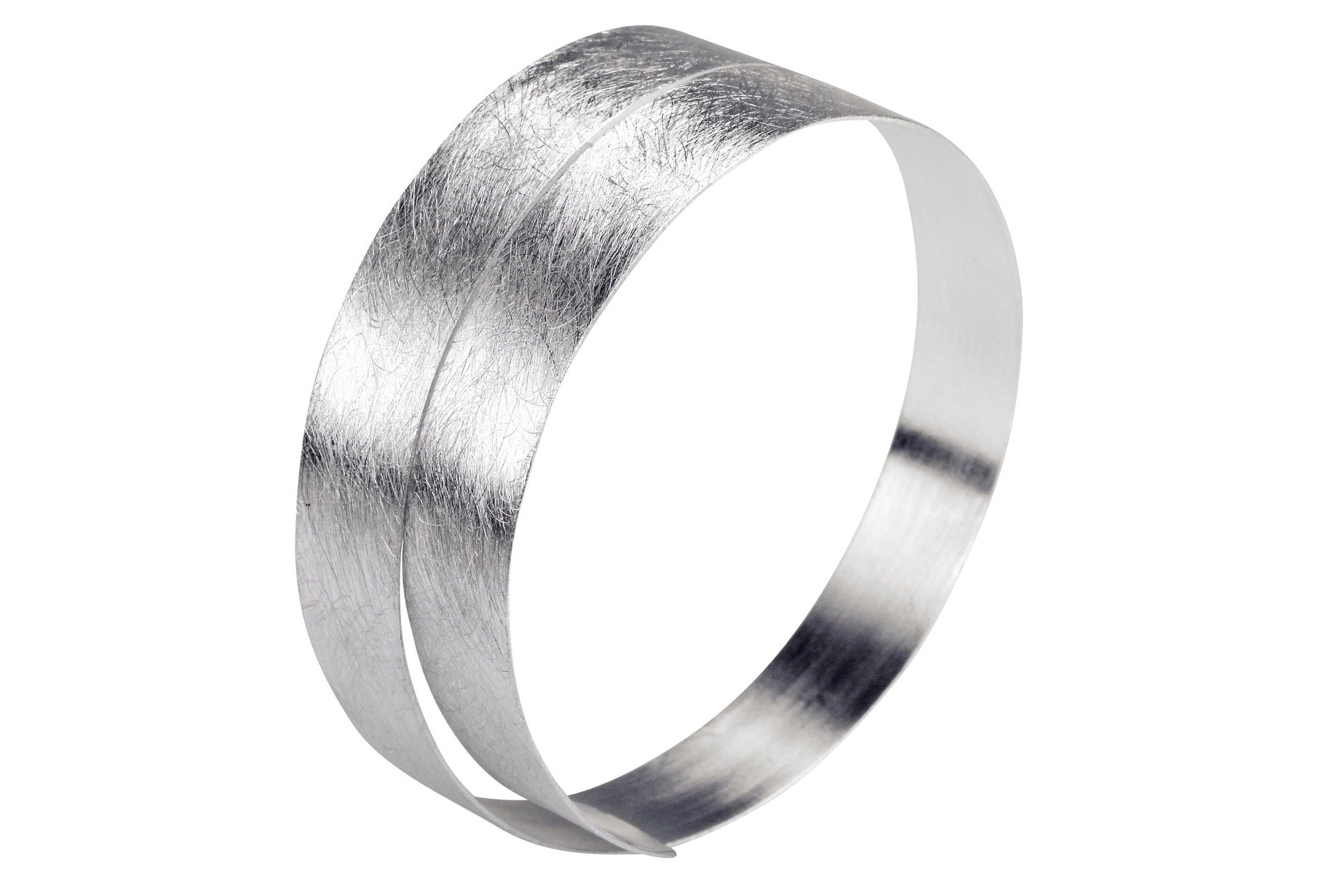 Ein schmaler und flexibler Armreif aus Silber für Damen.